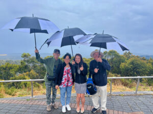 four people with umbrellas touring adelaide